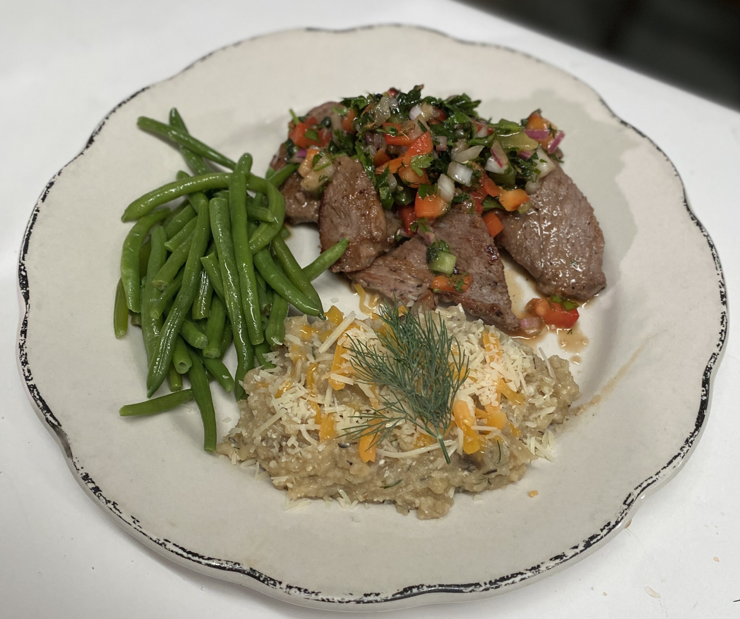 Chimichuri on beef with green beans and mashed potatoes.